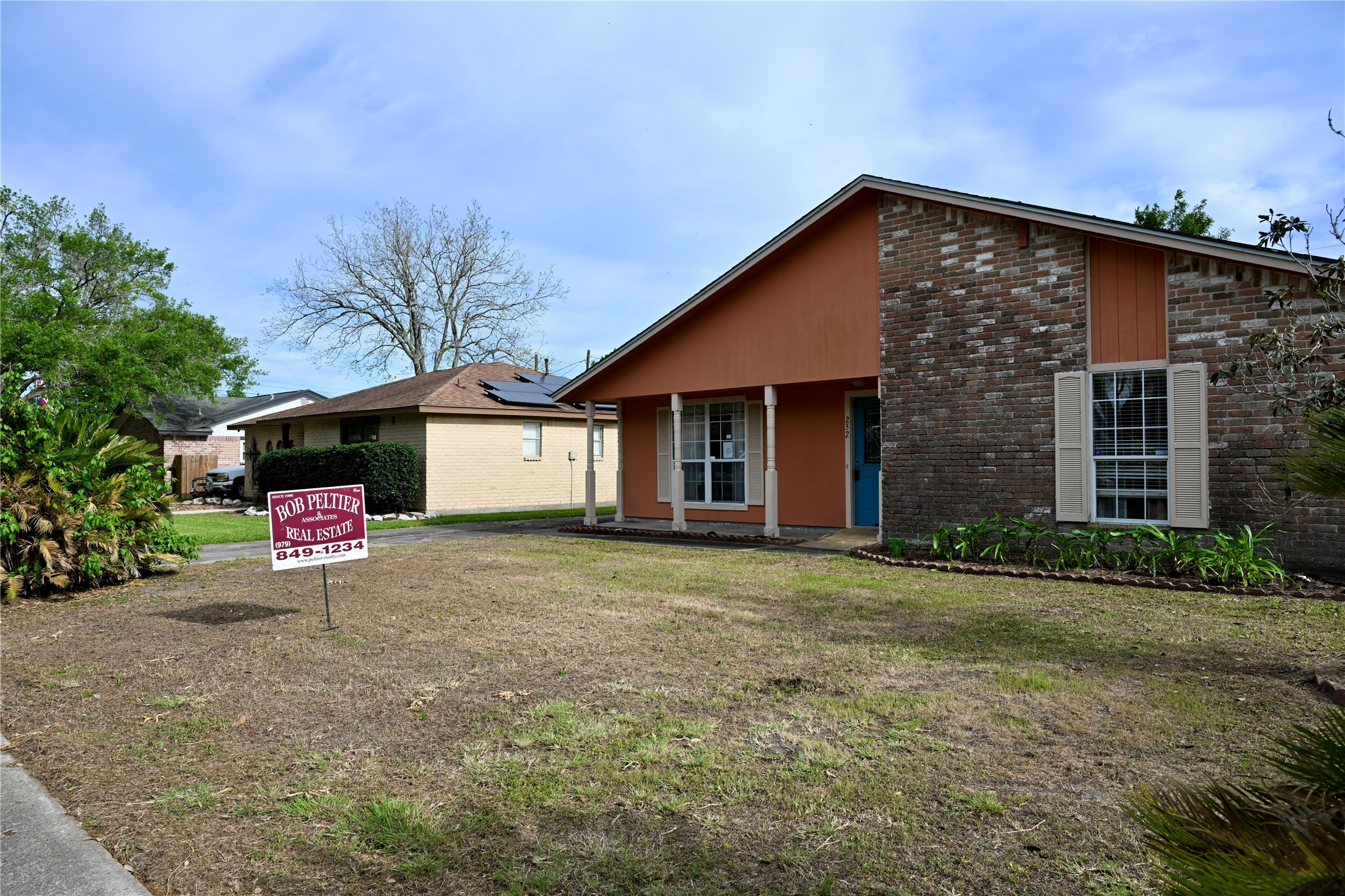 252 Bastrop Street Angleton, TX 77515 - Photo 6 of 28 a view of a house with a yard and garage