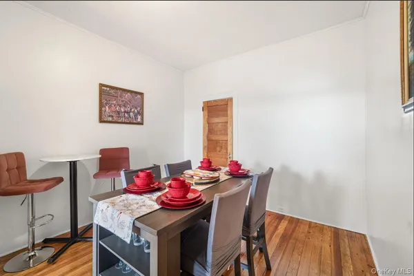 a view of a dining room with furniture and wooden floor