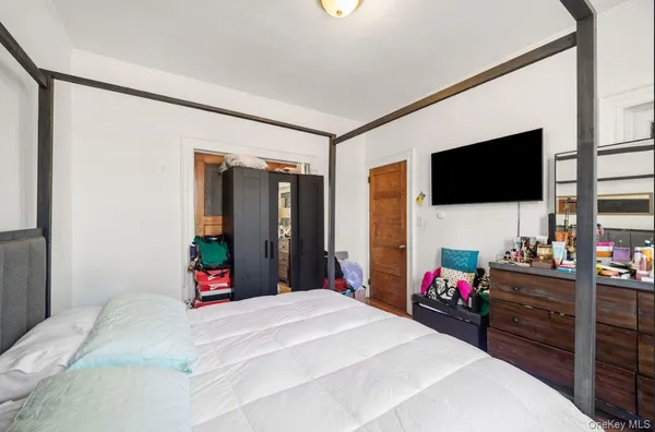 a bedroom with a bed and flat screen tv
