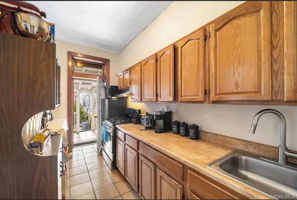 a kitchen with stainless steel appliances a sink a stove and a refrigerator