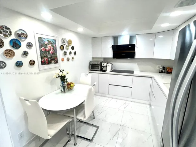 a kitchen with stainless steel appliances kitchen island granite countertop a sink and a microwave