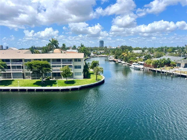 a view of a pool with a table and chairs