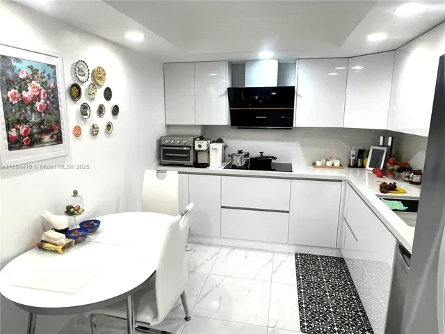 a kitchen with stainless steel appliances a sink a stove a microwave and cabinets