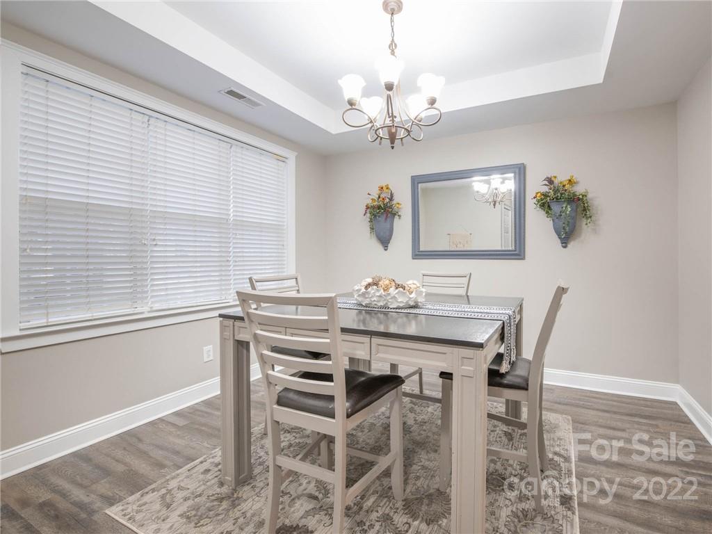 5725 Coopers Ridge Lane Charlotte, NC 28269 - Photo 11 of 39 a view of a dining room with furniture window and wooden floor