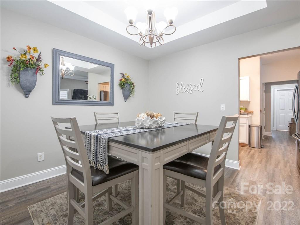5725 Coopers Ridge Lane Charlotte, NC 28269 - Photo 12 of 39 a view of a dining room with furniture and wooden floor