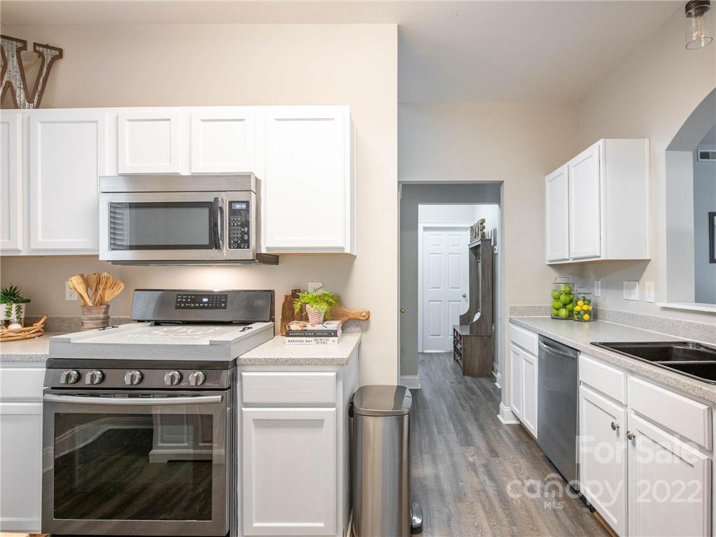 5725 Coopers Ridge Lane Charlotte, NC 28269 - Photo 15 of 39 a kitchen with a stove a sink and a microwave