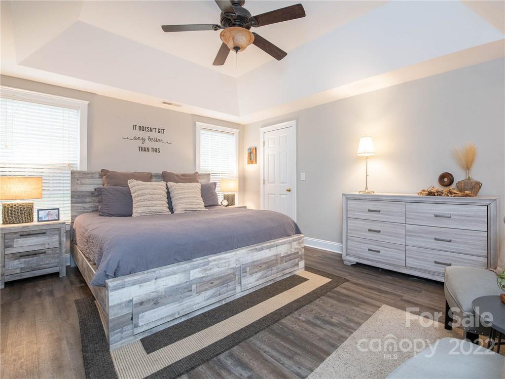 5725 Coopers Ridge Lane Charlotte, NC 28269 - Photo 20 of 39 a bedroom with a bed and wooden floor