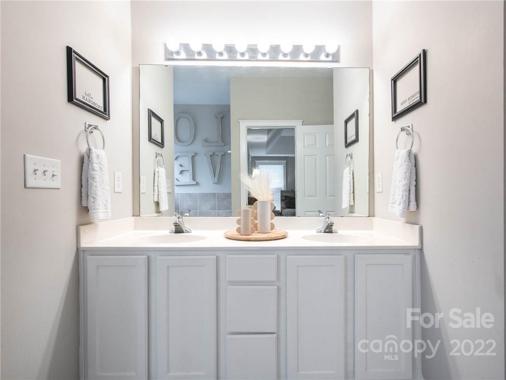 5725 Coopers Ridge Lane Charlotte, NC 28269 - Photo 22 of 39 a bathroom with a sink and a mirror