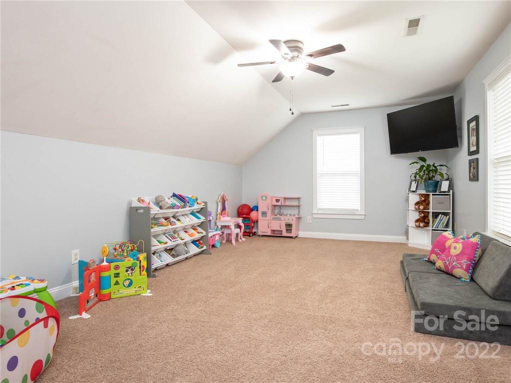 5725 Coopers Ridge Lane Charlotte, NC 28269 - Photo 27 of 39 a view of a room with toys and a flat screen tv