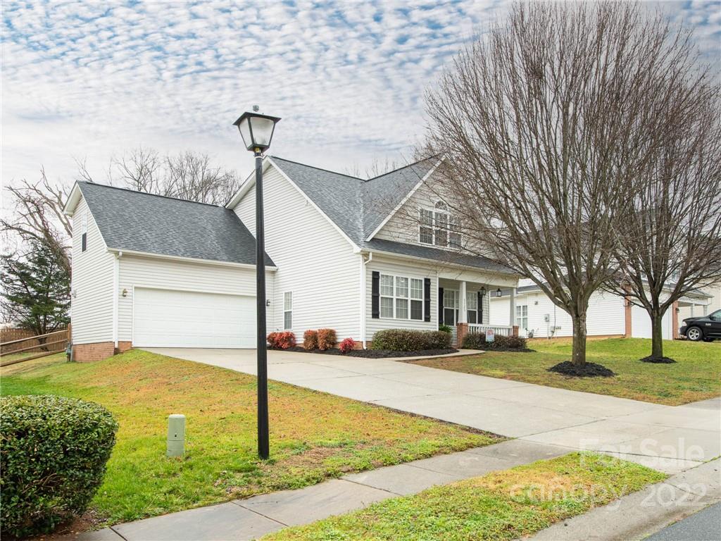 5725 Coopers Ridge Lane Charlotte, NC 28269 - Photo 3 of 39 a front view of a house with a yard