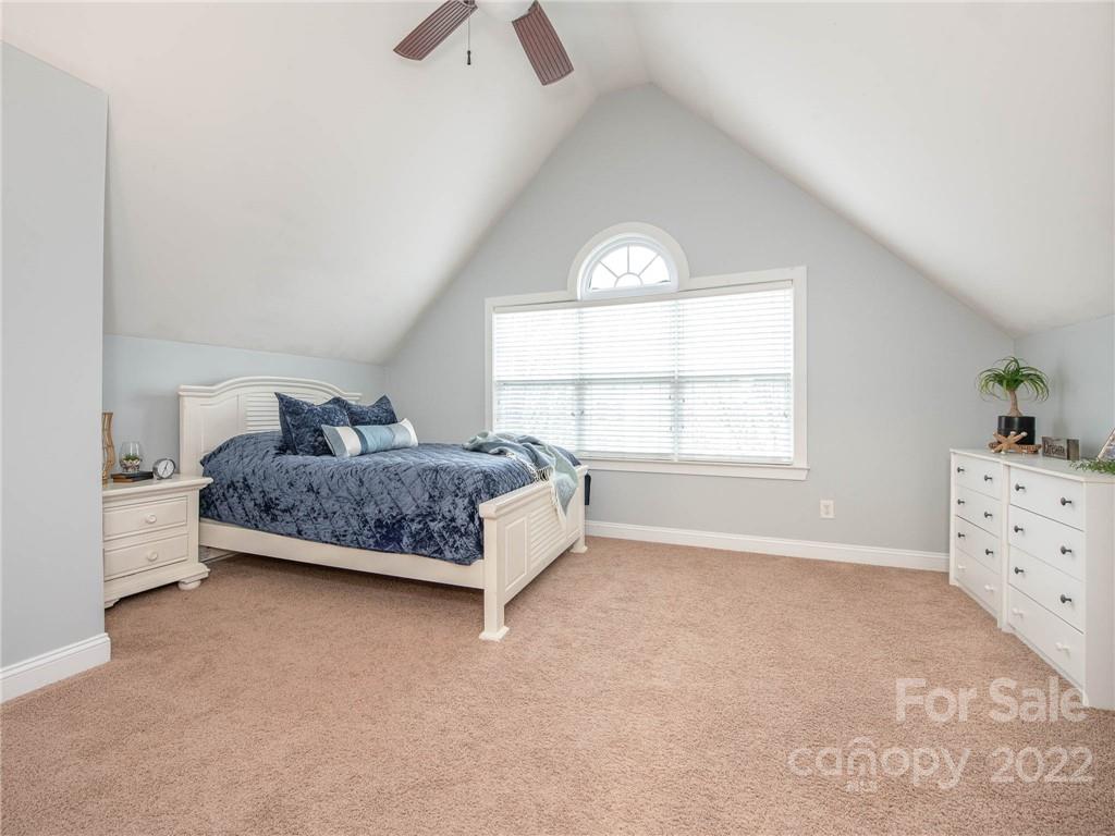 5725 Coopers Ridge Lane Charlotte, NC 28269 - Photo 32 of 39 a bedroom with a bed and a window