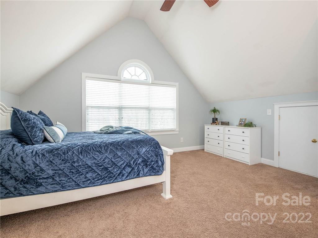 5725 Coopers Ridge Lane Charlotte, NC 28269 - Photo 33 of 39 a living room with a bed and a window