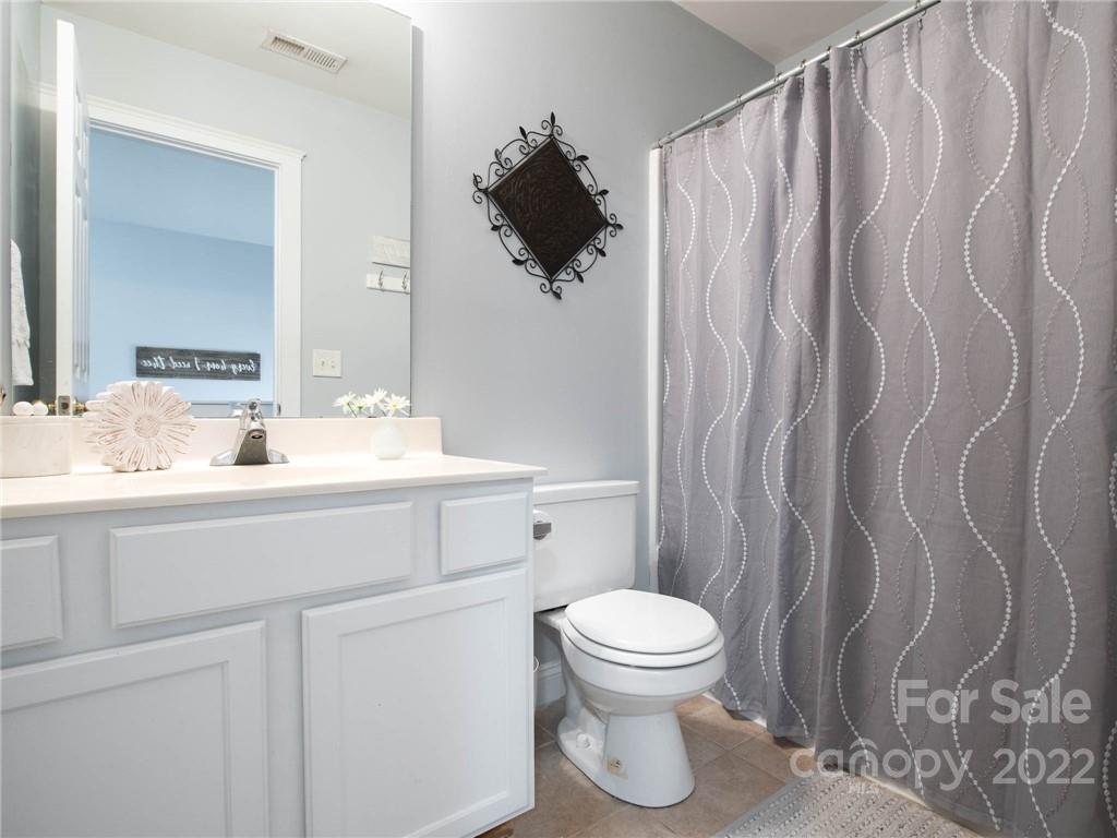 5725 Coopers Ridge Lane Charlotte, NC 28269 - Photo 35 of 39 a bathroom with a sink vanity mirror and toilet