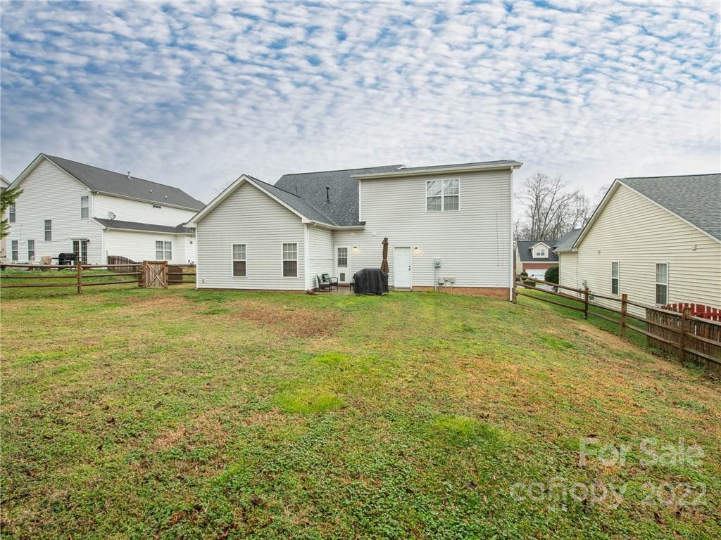 5725 Coopers Ridge Lane Charlotte, NC 28269 - Photo 37 of 39 a view of a house with a yard
