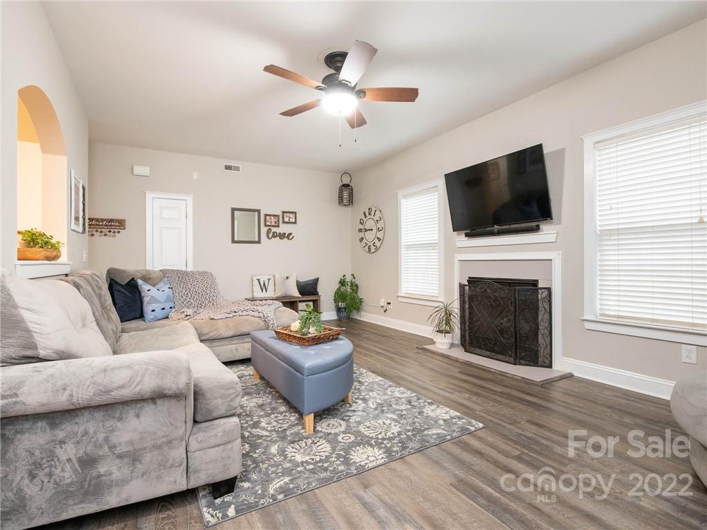 5725 Coopers Ridge Lane Charlotte, NC 28269 - Photo 7 of 39 a living room with furniture a fireplace and a flat screen tv
