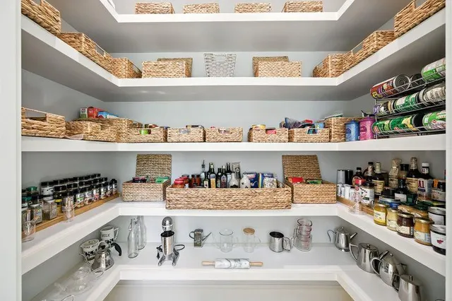 a bedroom with a bed and large windows