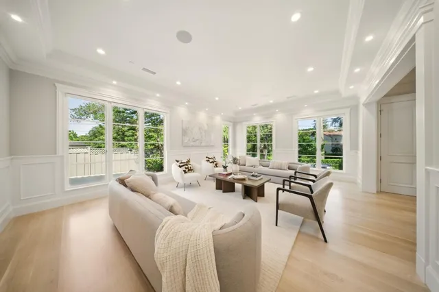 a view of a backyard with swimming pool and sitting area