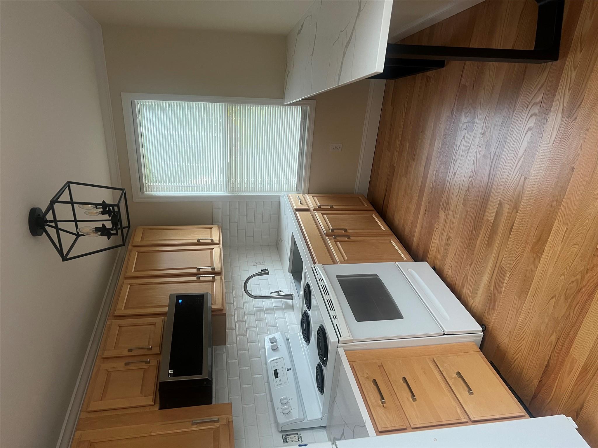 161 Main Street Cold Spring, NY 10516 - Photo 2 of 8 a kitchen with stainless steel appliances a stove a sink and white cabinets