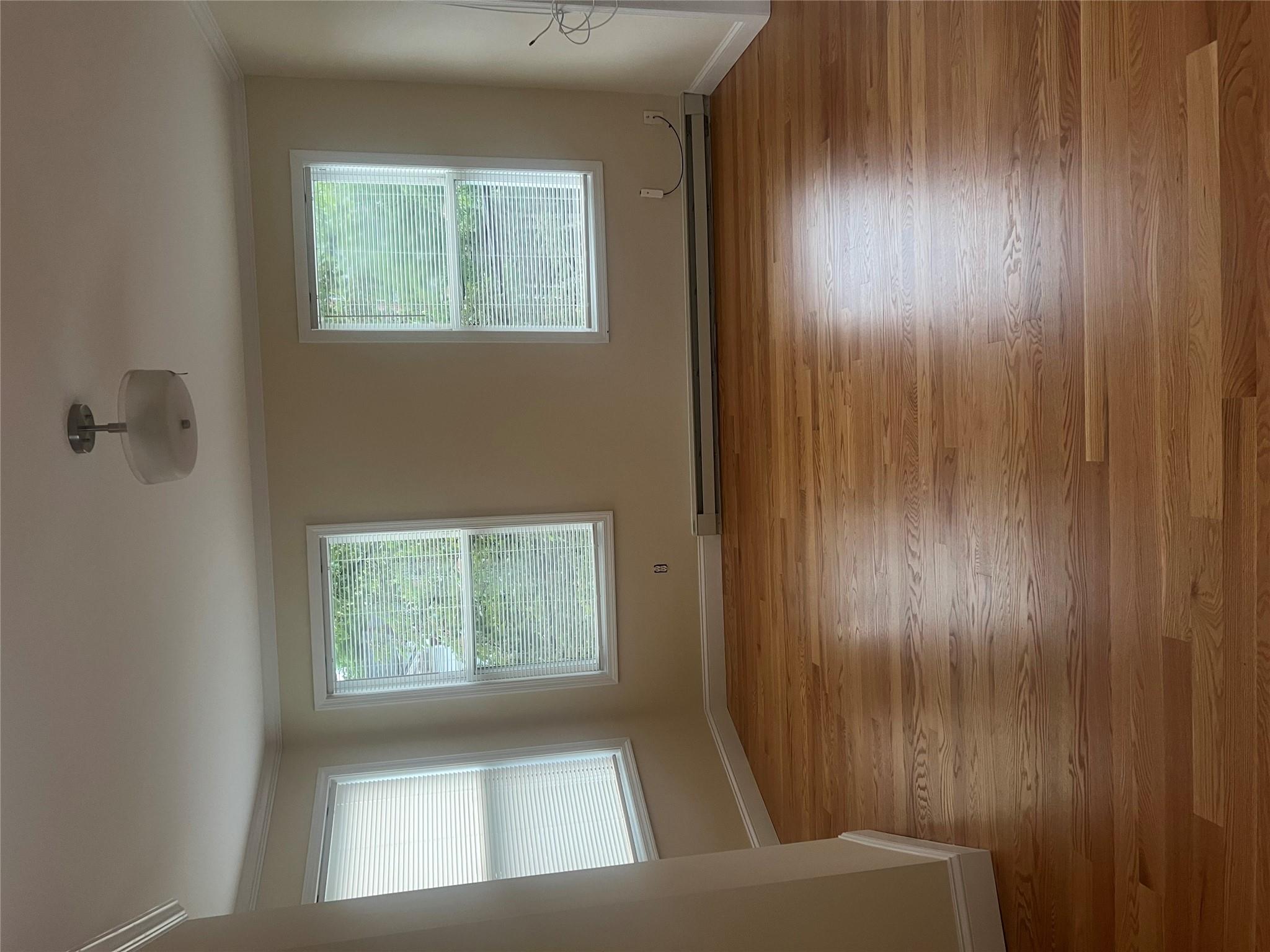 161 Main Street Cold Spring, NY 10516 - Photo 3 of 8 an empty room with wooden floor and windows