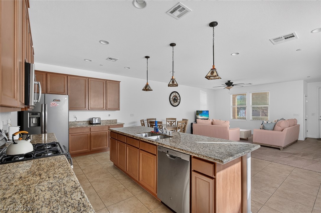 1100 East Sunset Road Henderson, NV 89011 - Photo 14 of 58 A well-appointed kitchen and living area feature warm wood cabinetry and granite countertops.