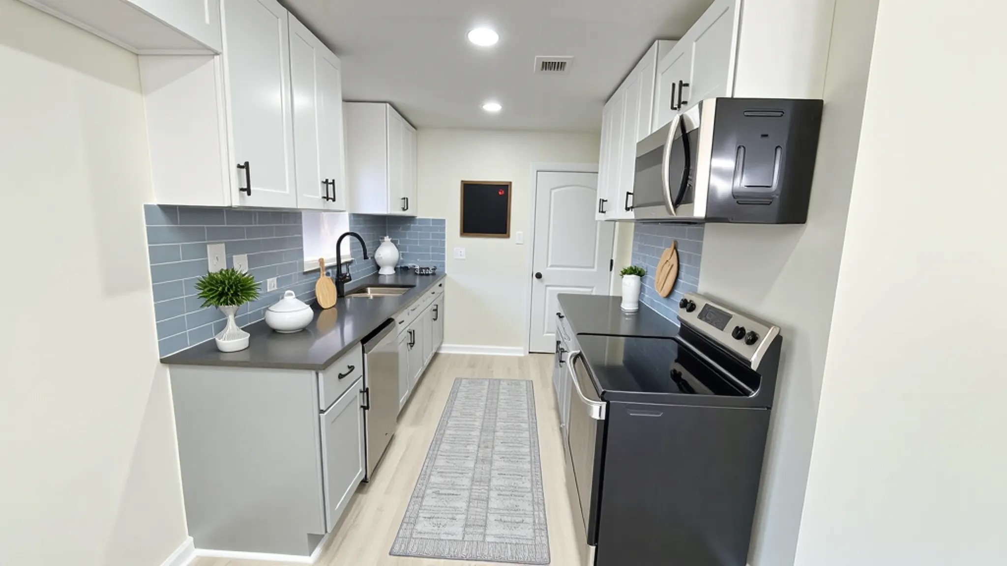 a kitchen with stainless steel appliances granite countertop a refrigerator a stove top oven a sink and dishwasher