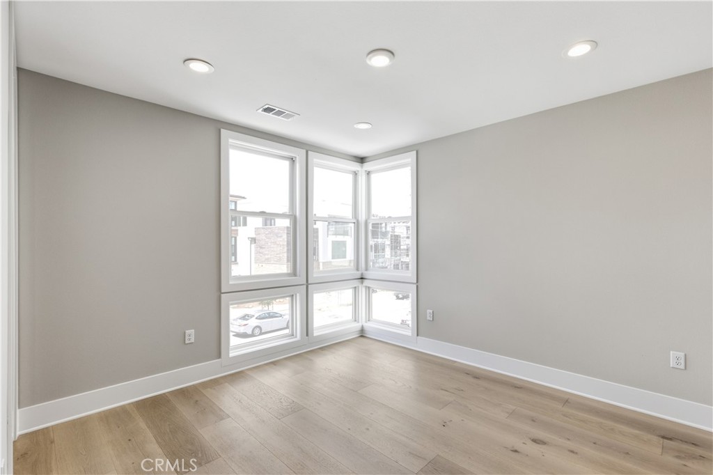 156 Apron Irvine, CA 92618 - Photo 22 of 40 wooden floor in an empty room with a window