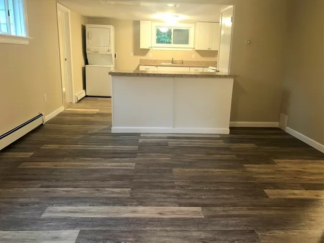 a view of a kitchen counter top space and wooden floor