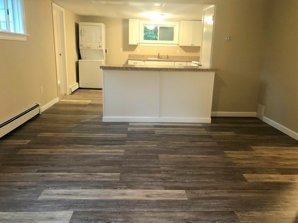 14 Rodgers Circle, Unit REAR North Reading, MA 01864 - Photo 3 of 8 a view of a kitchen counter top space and wooden floor