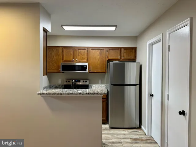 a kitchen with a refrigerator and a microwave