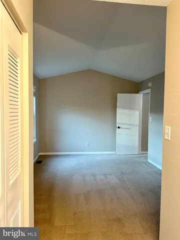 a view of an empty room and a window