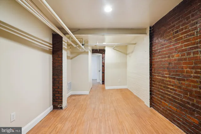a view of hallway with wooden floor
