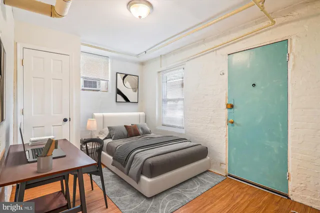 a bedroom with a bed and wooden floor