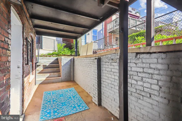 a view of entryway with a floor to ceiling window and wooden floor