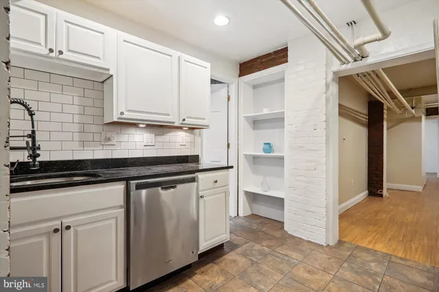 a kitchen with granite countertop white cabinets and white appliances