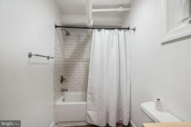 a bathroom with a shower curtain and a bathtub