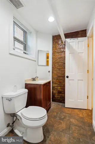 a bathroom with a toilet a sink and shower