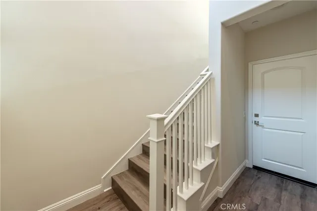 a view of a hallway with wooden floor and entryway