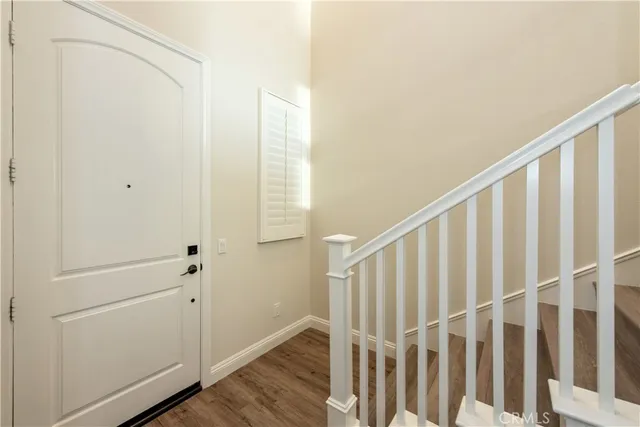 a view of a balcony with floor to ceiling window stairs and wooden floor