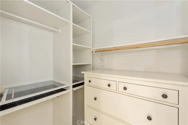 a bathroom with a sink double vanity granite tub shower and a mirror