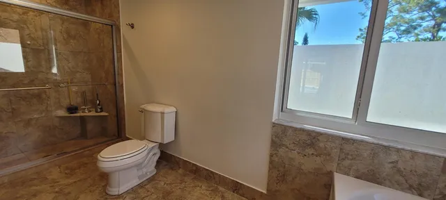 a bathroom with a granite countertop sink mirror and shower