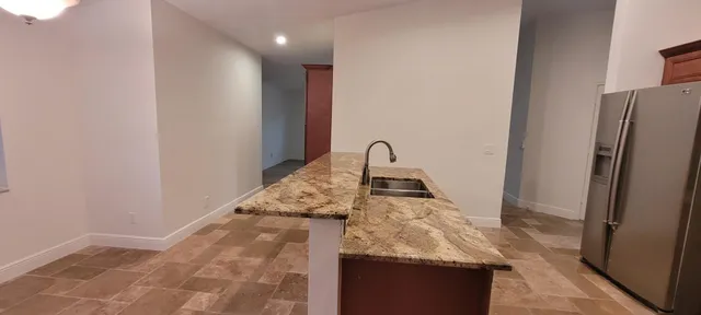 a view of kitchen with refrigerator stove and microwave