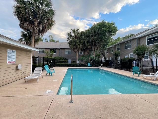4415 Southwest 34th Street, Unit 708 Gainesville, FL 32608 - Photo 8 of 9 a view of a house with swimming pool and sitting area