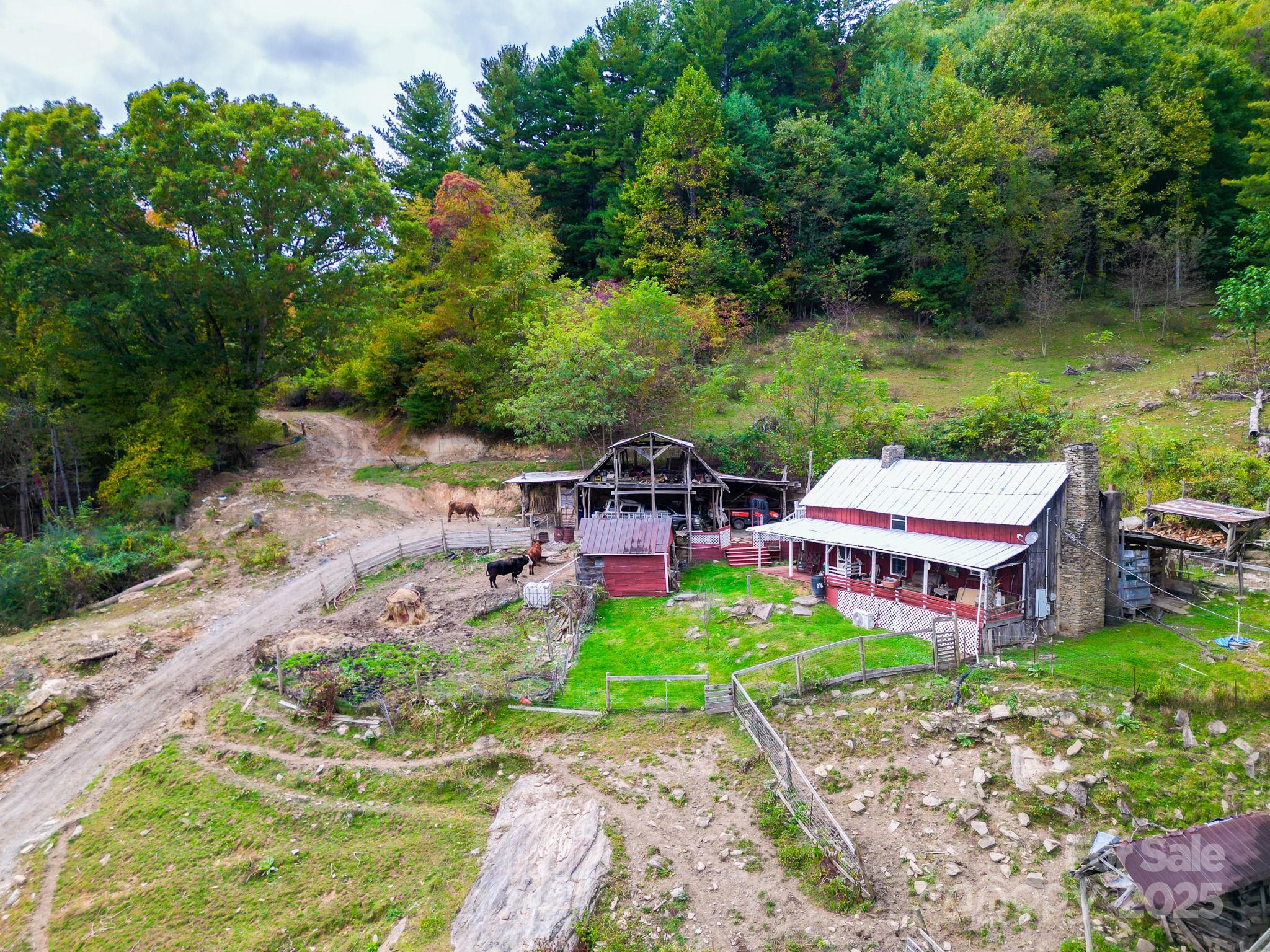 105 Home Place Road Maggie Valley, NC 28751 - Photo 17 of 24 an aerial view of a house with garden space and a patio
