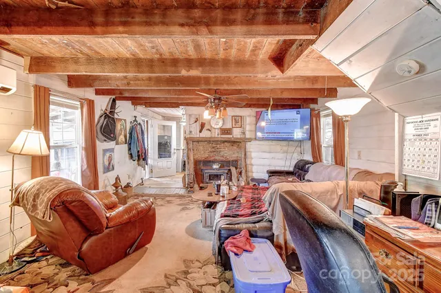 a view of a livingroom with furniture and a fireplace