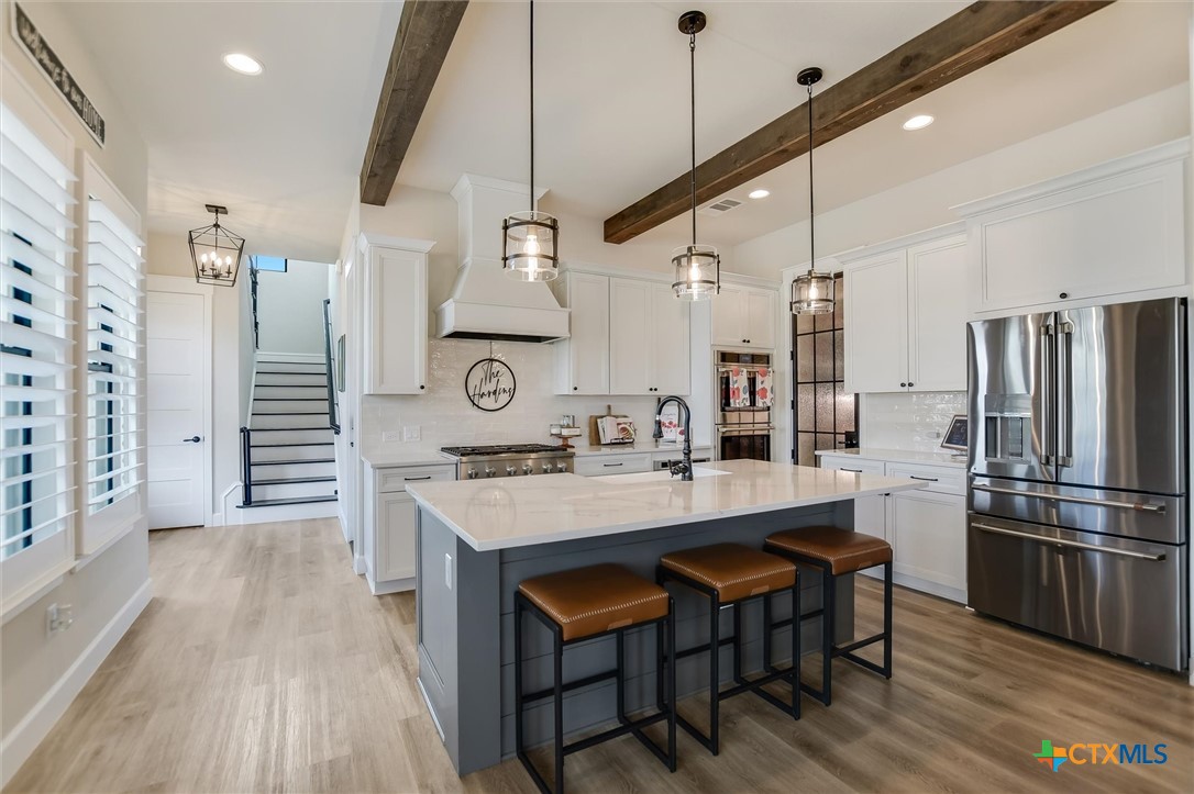 105 Retreat Place Georgetown, TX 78626 - Photo 12 of 42 a large kitchen with a table and chairs