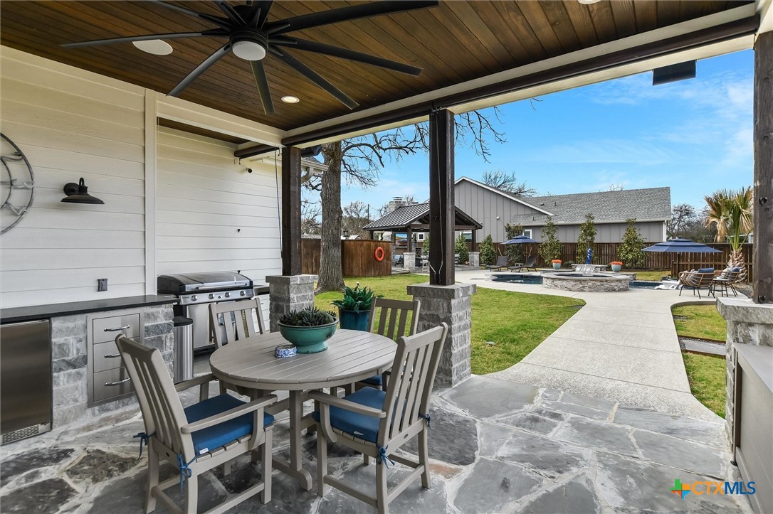 105 Retreat Place Georgetown, TX 78626 - Photo 29 of 42 a view of a patio with a table chairs and a swimming pool