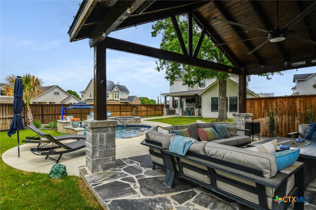 105 Retreat Place Georgetown, TX 78626 - Photo 31 of 42 a view of a patio with couches table and chairs with wooden floor and fence