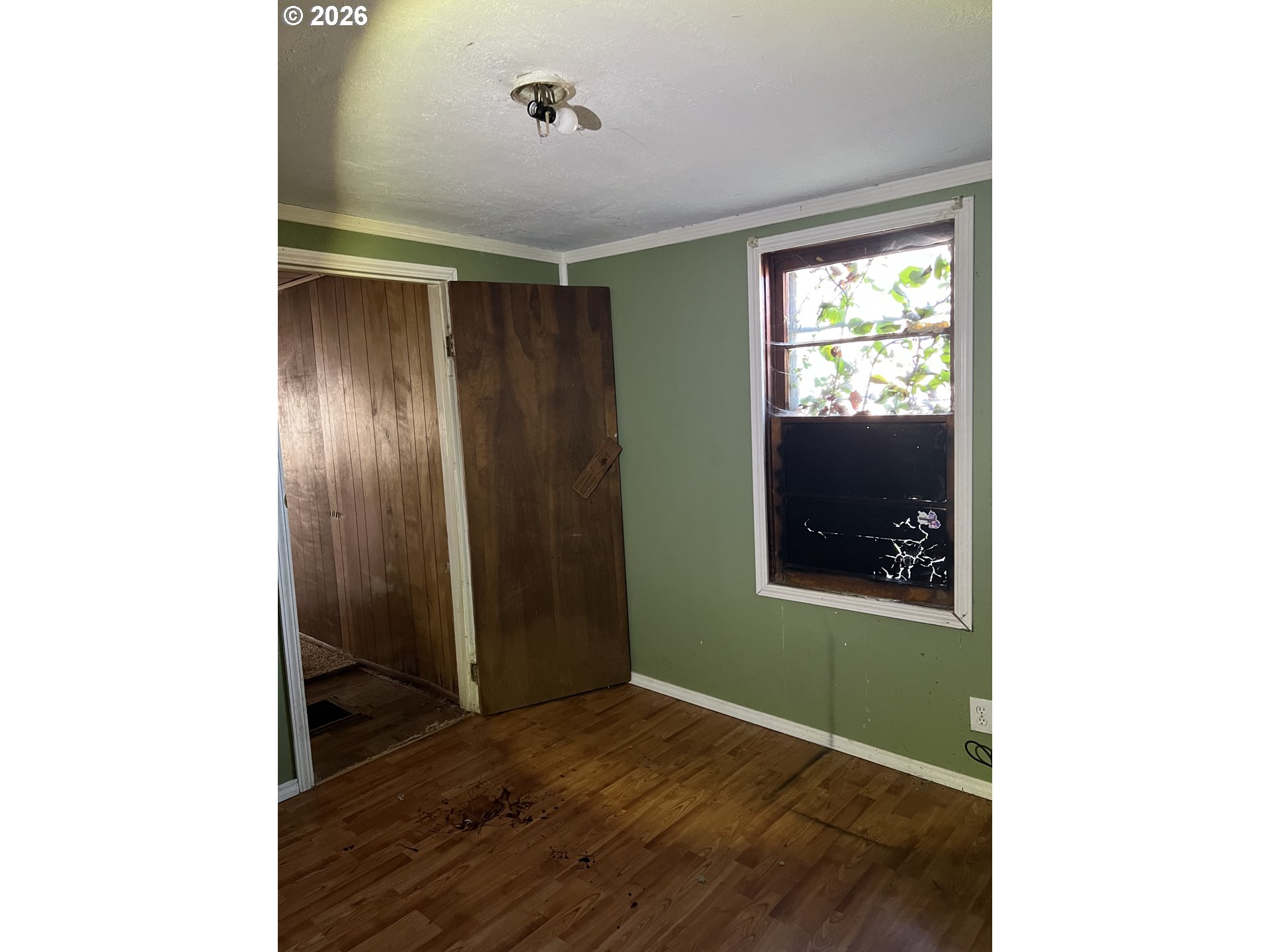 1161 Curtin Road Cottage Grove, OR 97424 - Photo 13 of 34 a view of an empty room with wooden floor and a window