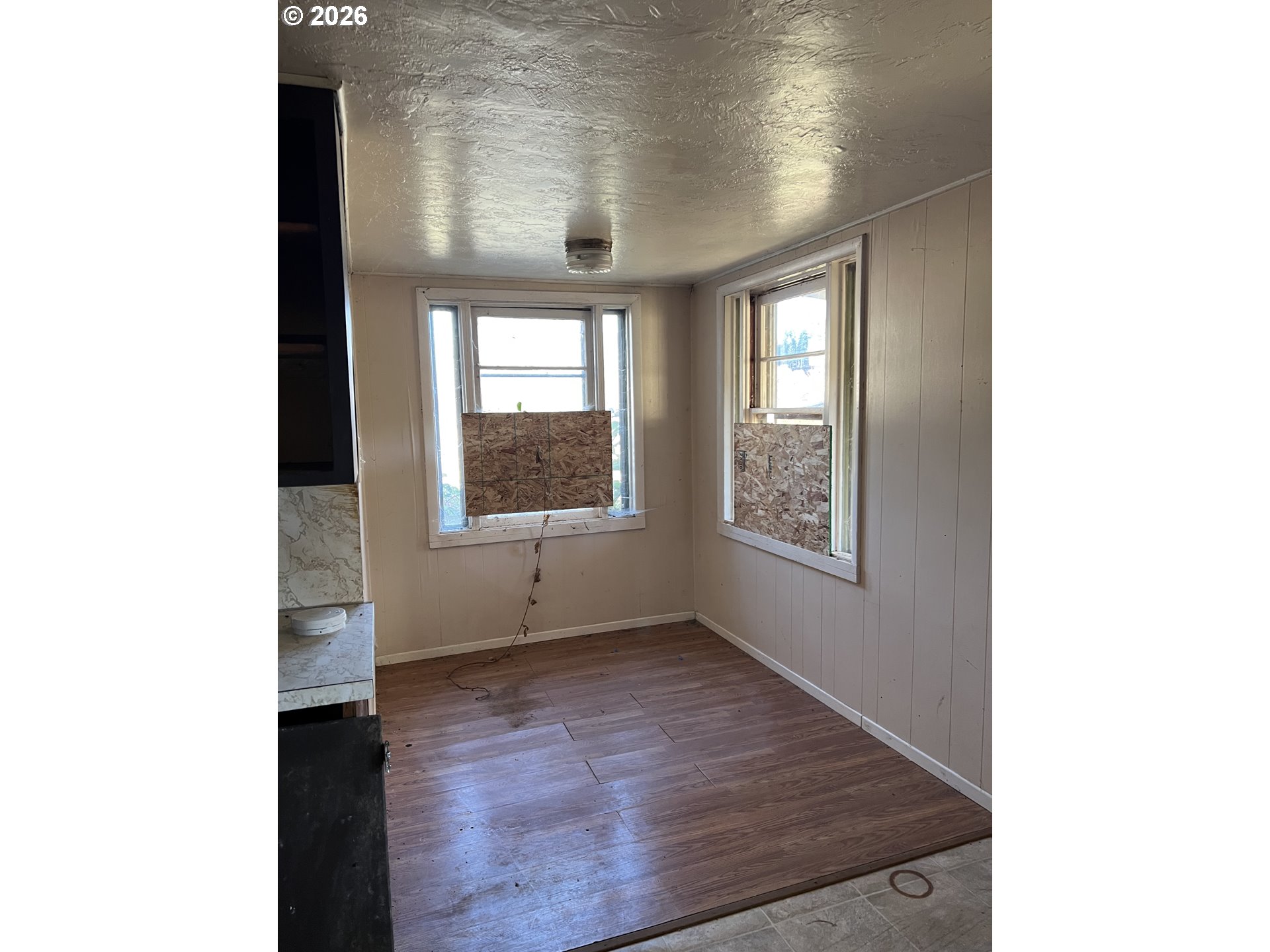 1161 Curtin Road Cottage Grove, OR 97424 - Photo 20 of 34 a view of an empty room with wooden floor and a window