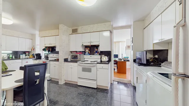 a kitchen with stainless steel appliances kitchen island granite countertop a stove sink and cabinets